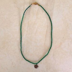 Dainty emerald green necklace with tiny crown.